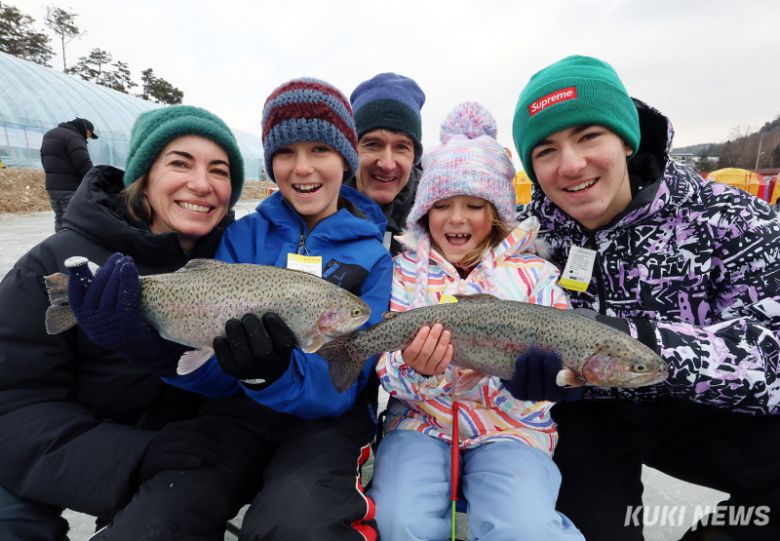 9일 강원도 평창군 진부면 오대천 일원에 개막한 대한민국 대표 겨울 축제 '2026년 제17회 평창송어축제장'을 찾은 외국인들이 얼음낚시 체험을 통해 잡은 송어를 들어보이고 있다. 평창군·축제위원회 제공