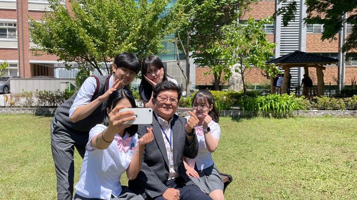 최경호 근명고 교장과 학생들이 교정에서 사진을 찍고 있다.