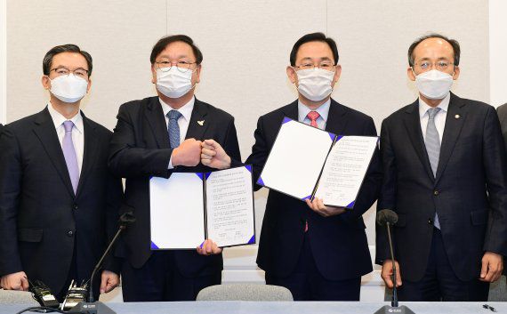 김태년 더불어민주당 원내대표와 주호영 국민의힘 원내대표가 22일 국회에서 2020년도 제4차 추가경정예산안 합의문에 서명한 후 합의문을 들고 포즈를 취하고 있다. 왼쪽부터 정성호 국회 예결위원장, 김태년 더불어민주당 원내대표, 주호영 국민의힘 원내대표, 추경호 예결위 간사. 사진=서동일 기자