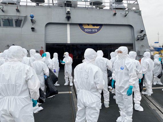 코로나19 집단감염이 발생한 청해부대 34진을 국내로 이송하기 위해 출국한 특수임무단 중 방역인력이 지난 19일 아프리카 해역에서 해군 구축함 '문무대왕함'에 승선해 방역작업을 준비하고 있다. / 사진=국방부 제공