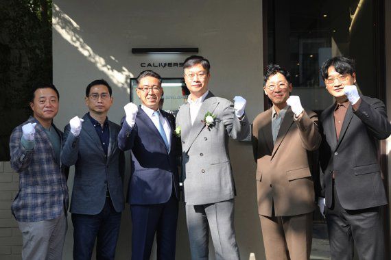 롯데정보통신 노준형 대표이사(왼쪽 세번째)와 칼리버스 김동규 대표이사(오른쪽 세번째) 및 관계자들이 현판 제막식 후 기념사진을 촬영하고 있다. 롯데정보통신 제공
