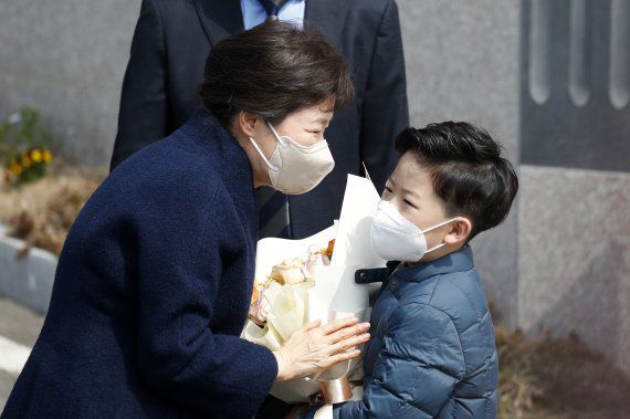 지난해 특별사면 후 입원치료를 하다 퇴원한 박근혜 전 대통령이 24일 오후 대구시 달성군 사저에 도착해 동네 초등학생에게 환영 꽃다발을 받고 있다. 사진=뉴스1