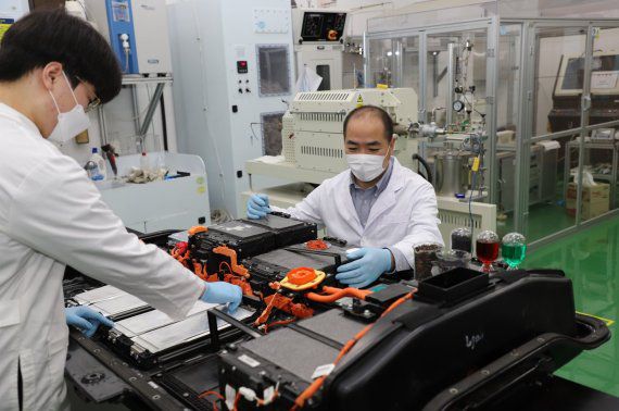 한국지질자원연구원 순환자원연구센터 배터리재활용연구단 김홍인 센터장(오른쪽)이 전기차 폐배터리에서 희소금속을 추출하기 위해 폐배터리셀을 분리하고 있다. 지질자원연구원 제공