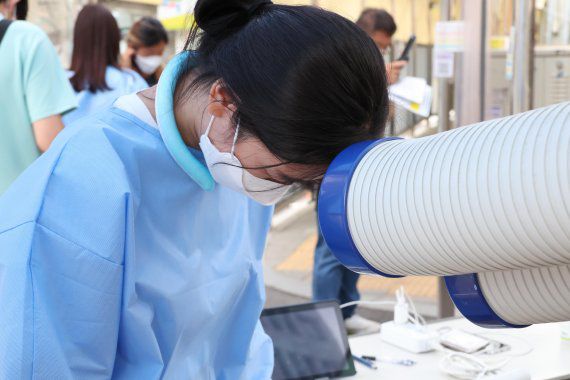 6일 서울 중구보건소 선별진료소에서 의료진이 냉풍기로 더위를 식히고 있다. 사진=박범준 기자                                     6일 서울 중구보건소 선별진료소에서 의료진이 냉풍기로 더위를 식히고 있다. 사진=박범준 기자