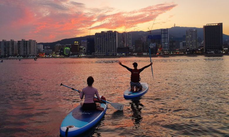 부산의 해양자원을 살린 관광기업들이 서핑, 요트를 비롯한 레저스포츠 등을 활용해 지역 관광 콘텐츠를 더 풍성하게 만들어주고 있다. 사진은 노을 지는 저녁 부산지역 해수욕장에서 해양레포츠를 즐기고 있는 사람들의 모습. 한국관광공사 제공