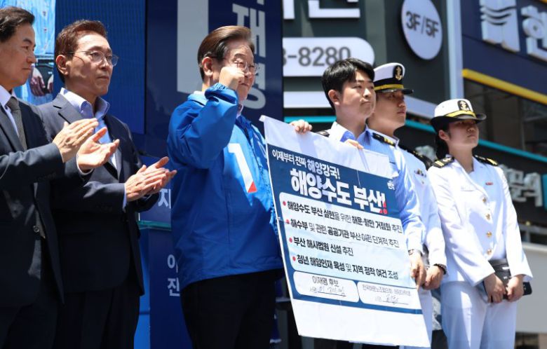 [부산=뉴시스] 권창회 기자 = 이재명 더불어민주당 대선 후보가 14일부산 부산진구 서면 젊음의 거리에서 열린 유세에서 권기흥 에이치라인해운해상직원노조 위원장과 해양수도 부산 협약서에 서명한 뒤 기념촬영을 하고 있다.2025.05.14. kch0523@newsis.com /사진=뉴시스                                    (부산=뉴스1) 김민지 기자 = 김문수 국민의힘 대통령 후보가 13일 부산 산업은행 이전 부지를 찾아 브리핑을 듣고 있다. 2025.5.13/뉴스1 /사진=뉴스1화상