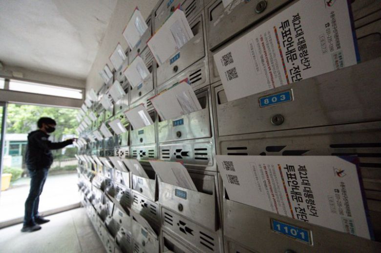 지난 24일 경기 수원시의 한 아파트 단지의 우편함에 제21대 대선 관련 투표 안내문 및 전단형 선거공보물이 도착한 가운데 한 주민이 이를 살펴보고 있다.뉴스1