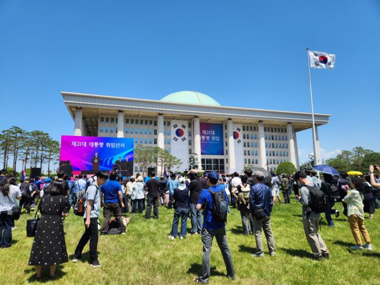 4일 오전 서울 여의도 국회의사당 앞 잔디광장에서 지지자들이 이재명 대통령 취임선서식을 보고 있다. 사진=박성현 기자