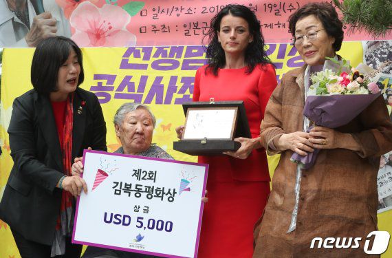 2019년 6월 19일 서울 종로구 옛 일본대사관 앞에서 열린 제1392차 일본군 성노예제 문제 해결을 위한 정기 수요시위에서 코소보 내전 생존자인 바스피예 크라스니치-굿맨이 '제2회 김복동평화상'을 수상하고 있다. 왼쪽부터 윤미향 당시 정의연 상임대표, 위안부 피해자 길원옥, 바스피예 크라스니치-굿맨, 이용수 할머니. © News1 /사진=뉴스1