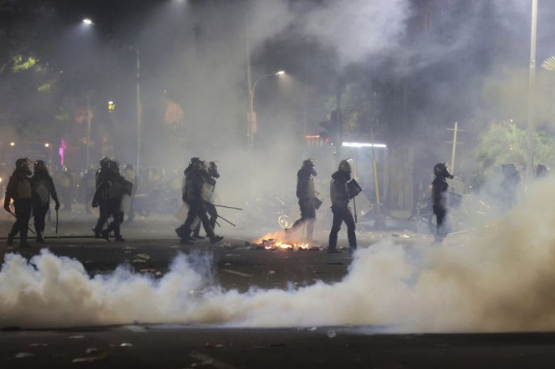 인도네시아 경찰이 30일 동부 자바 수라바야에서 최루탄을 터뜨리며 시위를 진압하고 있다. AP 뉴시스