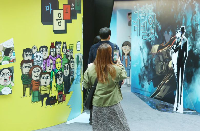 19일 서울 송파구 롯데월드 아이스링크에서 열린 '2025 월드 웹툰 페스티벌'을 찾은 관람객들이 웹툰 기획 전시를 살펴보고 있다. 연합뉴스