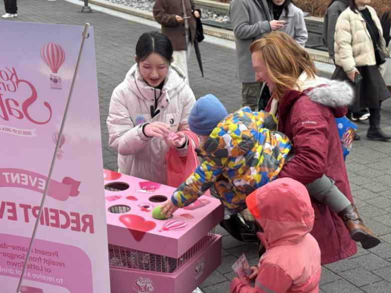 롯데백화점 잠실점에서 지난달 열린 플레이 트럭 팝업스토어 현장에서 외국인 관광객들이 'K-쇼핑 카트 채우기' 이벤트를 즐기고 있다. 롯데쇼핑 제공