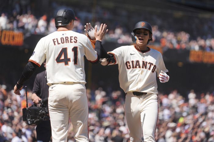 이정후가 8회 투런홈런을 터뜨리고 들어와 먼저 홈을 밟은 윌머 플로레스의 환영을 받고 있다. AP연합뉴스