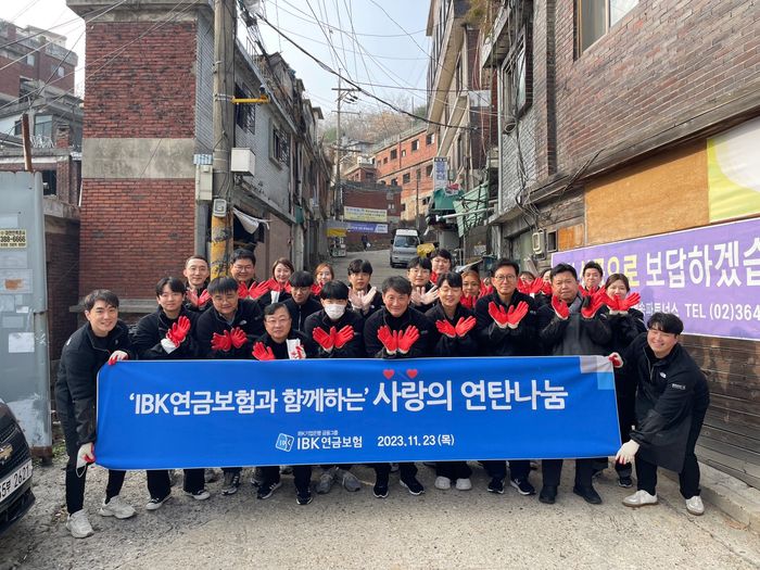 IBK연금보험 임직원들이 23일 서울 서대문구 현저동 일대의 저소득 고령 어르신 가정에 ‘사랑의 연탄나눔’ 봉사를 실시하고 기념촬영을 하고 있다.[사진 제공 =  IBK연금보험 ]