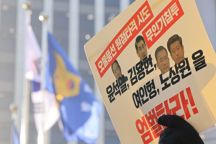 지난 26일 오전 서울 서대문구 경찰청 국가수사본부 앞에서 ‘평화와 연대를 위한 접경지역 주민·종교·시민사회 연석회의’, ‘윤석열 즉각퇴진·사회대개혁 비상행동’ 관계자들이 윤석열 대통령과 김용현 전 국방부 장관, 여인형 국군방첩사령관, 노상원 전 정보사령관을 외환죄 혐의로 고발하기에 앞서 팸플릿을 들고 시위를 하고 있다. [사진 = 연합뉴스]