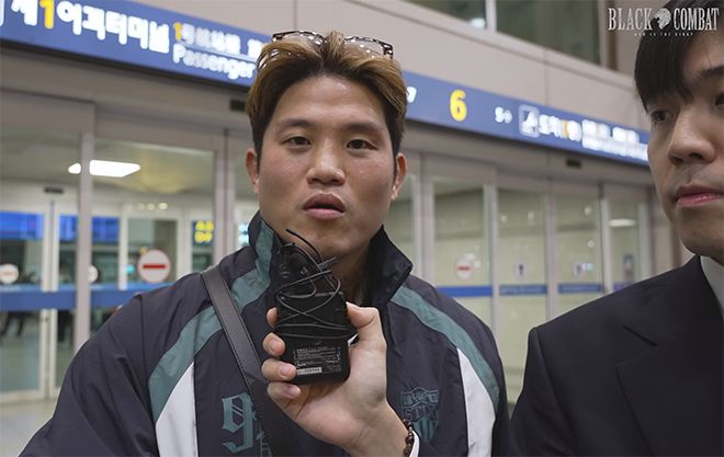 홍석현(오른쪽) 아나운서가 ‘최악의 코리안 갱스터 귀국 현장 인터뷰’에 출연한 초대 블랙컴뱃 웰터급 챔피언 결정전 참가 예정자 박원식 답변을 듣고 있다. 사진=이데아 파라곤 영상 화면