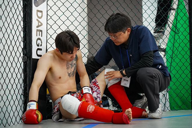 KMMA ‘로블로우 담당’ 케이지 닥터 멘파워비뇨기과 권상택(오른쪽) 원장이 ‘뽀빠이연합의원KMMA28대구’ 경기 도중 급소를 맞은 선수의 상태를 살펴보고 있다. 사진=스탠다드앤드프로그레스 스포츠에이전시 제공