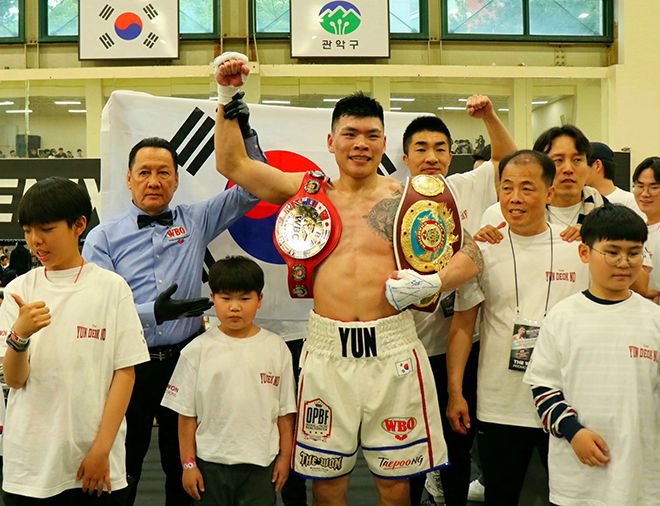 윤덕노가 2025년 4월 서울특별시 관악구민종합체육센터 슈퍼미들급 통합타이틀매치 승리 선언을 받으며 뿌듯해하고 있다. 챔피언 벨트는 왼쪽부터 동양태평양복싱연맹, 세계복싱기구 아시아태평양. 사진=KBM 사단법인 한국복싱커미션