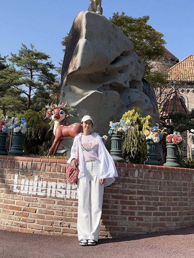 장신영은 루즈한 핏의 화이트 셔츠를 가볍게 걸치고, 그 안에 연핑크 레트로 프린팅 티셔츠를 매치해 사랑스러운 무드를 더했다. 사진=장신영 SNS