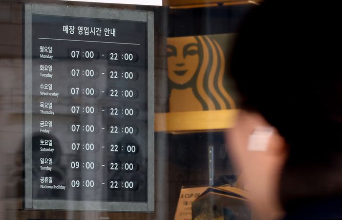 지난 12일 서울 시내 한 스타벅스 매장에 영업시간 안내문이 놓여 있다. [사진 = 연합뉴스]