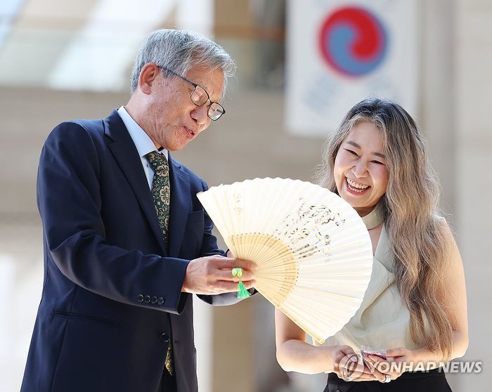 유홍준 국립중앙박물관장으로부터 부채를 선물 받는 ‘케데헌’ 매기 강 감독 [사진 = 연합뉴스]