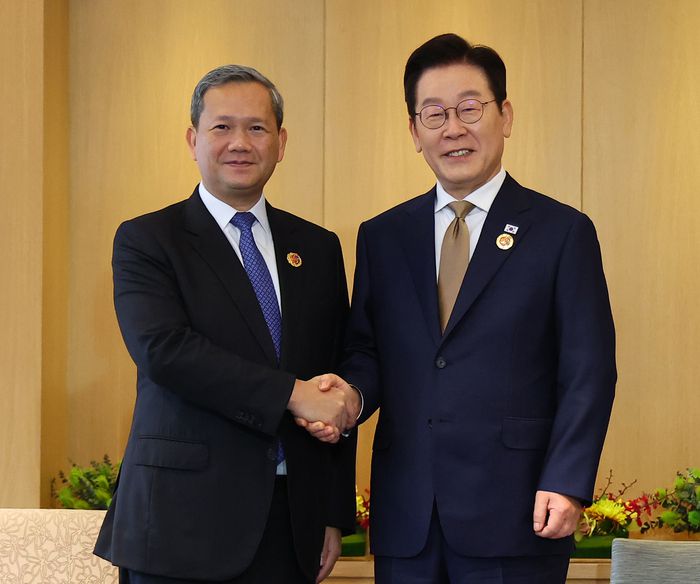 이재명 대통령과 훈 마네트 캄보디아 총리가 27일 말레이시아 쿠알라룸푸르 한 호텔에서 정상회담에 앞서 악수하고 있다. [연합뉴스]