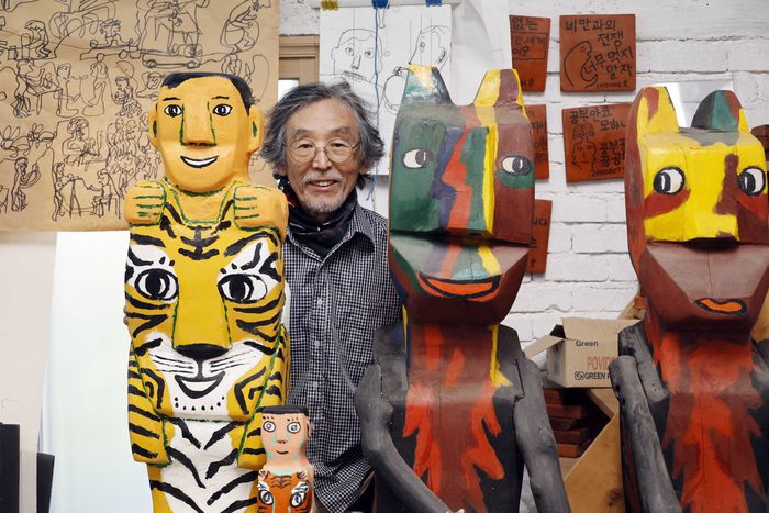 김종영 미술상 수상자인 조각가 김주호가 자신의 나무 조각 사이에서 사진을 찍고 있다. [김호영기자]