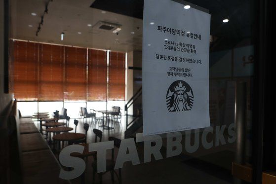 18일 경기도 파주 스타벅스 야당역점에 코로나19 확산 예방을 위한 휴점 안내문이 붙어 있다.   연합뉴스.