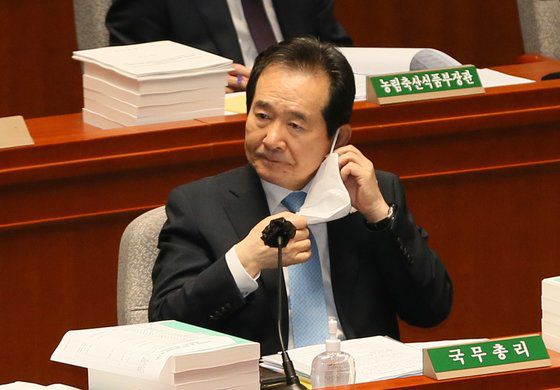 정세균 국무총리가 24일 오전 서울 여의도 국회에서 열린 예산결산특별위원회에서 의원의 질의에 답변하기 위해 마스크를 벗고 있다. 뉴스1