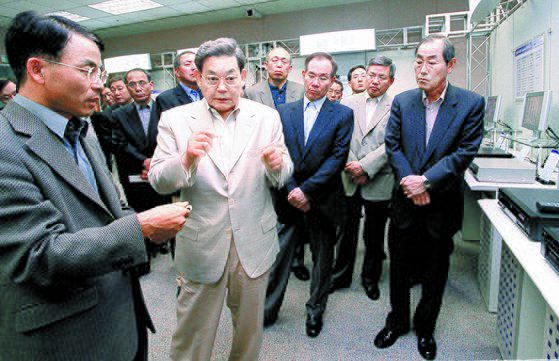 이건희 삼성 회장(앞줄 왼쪽 둘째)이 2002년 삼성 본사에서 열린 ‘디지털 신제품 전시회’에서 진대제 당시 삼성전자 사장(왼쪽 첫째)으로부터 제품에 대한 설명을 듣고 있다. 이 사내 전시회를 통해 경쟁사의 첨단 전자제품을 현장에서 접하도록 하면서 기술 개발의 중요성을 강조했다. [중앙포토]