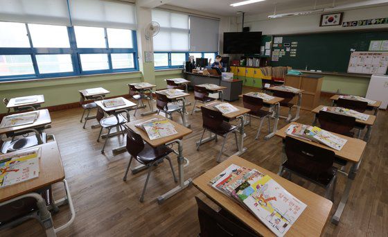 지난달 20일 서울의 한 초등학교에서 열린 온라인 방학식. 책상 위에는 학생들이 다음 학기에 사용할 교과서가 놓여 있다. 연합뉴스