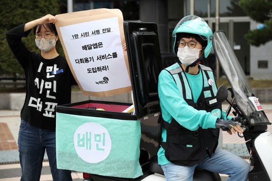 지난해 9월 2일 오전 서울 송파구 우아한형제들 앞에서 녹색연합 등 단체 주최로 열린 기자회견에서 참가자가 배달앱의 다회용기 서비스 즉각 도입을 촉구하고 있다. [연합뉴스]