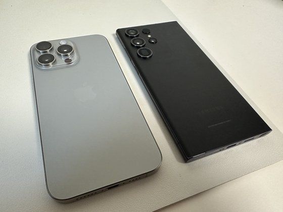 아이폰15 프로맥스와 삼성 갤럭시S23 울트라. 티타늄 프레임을 적용한 아이폰15 프로맥스의 무게는 221g으로 전작 대비 19g을 줄여 갤럭시S23 울트라(233g)보다 가벼워졌다. 이희권 기자