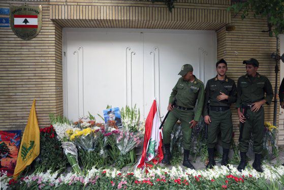 18일 이란 테헤란의 레바논 대사관 앞에 놓인 꽃 옆에서 이란 군인들이 경비를 서고 있다. 이날 이란 시민들은 연대의 의미로 레바논 대사관 앞에 꽃을 놓았다. EPA=연합뉴스