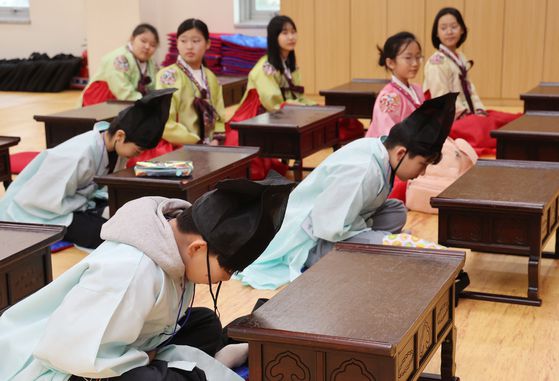지난달 6일 오전 부산 동래구 충렬사 안락서원 교육회관에서 열린 초등학교 겨울방학 전통문화체험교실에 참가한 초등생들이 한복을 차려입고 전통 예절을 배우고 있다. 연합뉴스