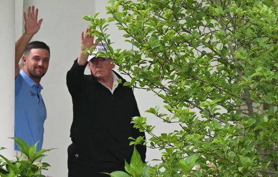 도널드 트럼프 미국 대통령이 1일(현지시간) 프로 골퍼 브라이슨 디샘보 선수와 골프 라운딩을 마친 뒤 백악관 오벌 오피스로 걸어들어가면서 기자들에게 손을 흔들고 있다. AFP=연합뉴스