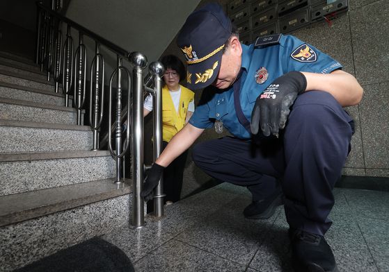 합동 점검반이 계단 난간 밑도 살피고 있다. 연합뉴스