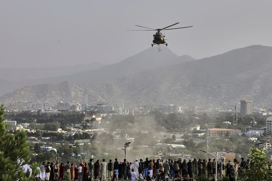 지난 8월 15일 아프가니스탄 수도 카불에서 열린 미국 철수 및 탈레반 통치 시작 4주년을 기념하는 행사에서 군용 헬리콥터가 도시 상공에 꽃을 떨어뜨리고 있다. AP=연합뉴스