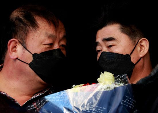 경찰 고문으로 살인 누명을 쓰고 21년간 억울한 옥살이를 한 '낙동강변 살인사건' 피해자 최인철(왼쪽)씨와 장동익씨가 4일 부산고등법원에서 무죄를 선고 받은 뒤 꽃다발을 들고 있다. [이미지출처=연합뉴스]