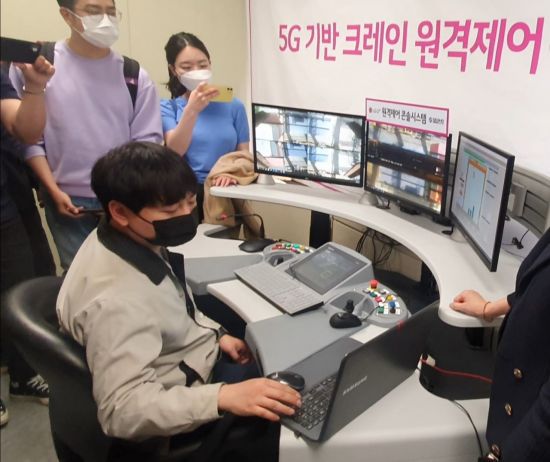 부산 신감만항에 마련된 크레인 원격제어실에서 5G 원격제어 크레인을 조종하고 있는 모습.