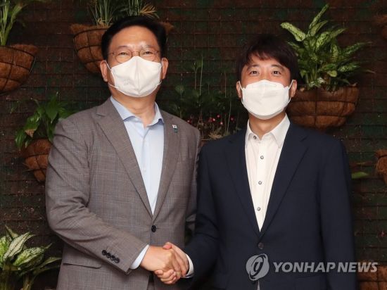 송영길 더불어민주당 대표(왼쪽)와 이준석 국민의힘 대표가 12일 서울 여의도의 한 식당에서 열린 만찬 회동에서 악수하고 있다. / 사진=연합뉴스