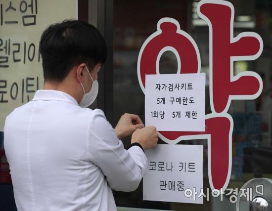 13일 서울 종로구 유성약국에서 관계자가 코로나19 자가검사키트 구매 관련 안내문을 붙이고 있다. 자가검사키트는 유통개선조치에 따라 이날부터 3월 5일까지 온라인판매가 금지되고 개인이 약국, 편의점에서 구매할 수 있는 물량은 한 번에 5개로 제한된다. 다만 하루에 여러번 구매하는 것에는 제한이 없으며, 온라인 재고 물량은 16일까지 판매할 수 있다./강진형 기자aymsdream@