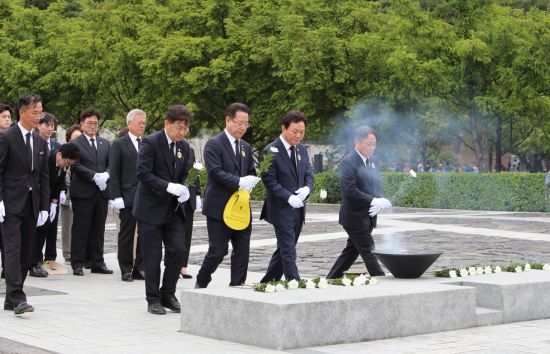 박완수 경남도지사(왼쪽 세 번째)가 故 노무현 전 대통령 묘역에 흰 국화를 올리고 있다. 이세령 기자