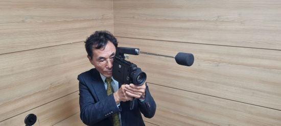 27일 오전 5·18민주화운동기록관에서 열린 시사회에서 미공개 필름 기증자 문제성씨가 1980년 5월 당시 촬영했던 카메라를 들고 재현하고 있다. 민찬기 기자