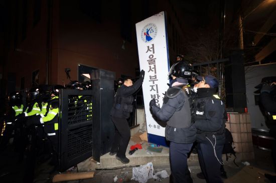 경찰이 지난 1월 서울서부지방법원 습격으로 서울지법 후문에 쓰러진 현판을 세우고 있다. 연합뉴스