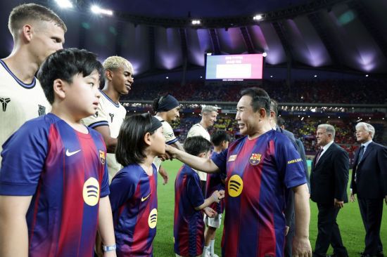 윤홍근 제너시스BBQ그룹 회장이 BBQ 창사 30주년 기념으로 서울월드컵경기장에서 열린 FC바르셀로나와 FC서울의 친선경기에 앞서 양팀 선수들을 격려하고 있다. 올리브 크리에이티브 제공