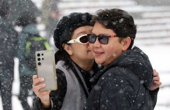 서울에 20cm에 이르는 폭설이 내린 27일 서울 중구 남산 전망대를 찾은 외국인 관광객이 기념사진을 찍고 있다. 조용준 기자