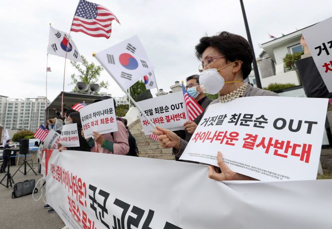 지난 27일 오후 강원 춘천시 강원도청에서 열린 ‘강원 차이나타운 건설 백지화 및 최문순 도지사 사퇴 촉구’ 집회에서 보수단체 회원들이 태극기와 성조기를 흔들며 구호를 외치고 있다 (사진=연합뉴스)