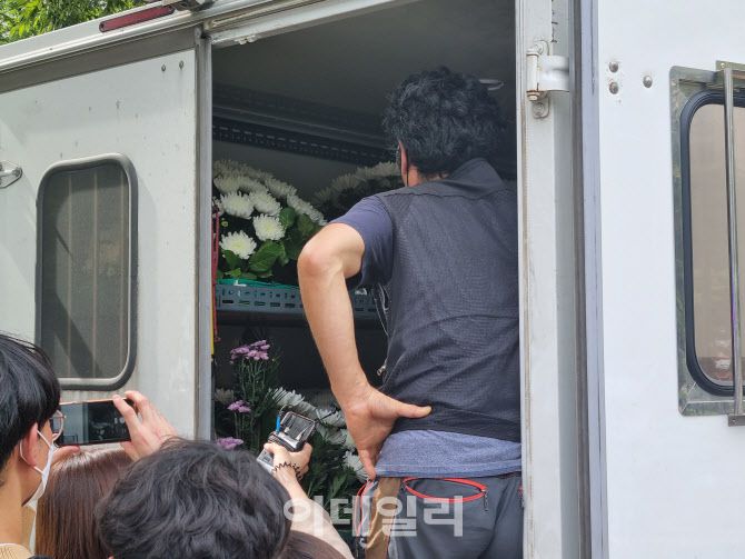 16일 오후 서울 여의도 국회 앞 자영업자 합동분향소 설치를 위해 조화 등을 실은 차량에서 관계자가 대기하고 있다.(사진=조민정 기자)