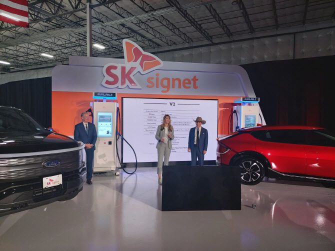 오승준 SK시그넷 미국법인장(왼쪽 세번째)과 존 먼스 미국 텍사스주 플레이노 시장(왼쪽 첫번째)이 5일(현지시간) 플레이노에 위치한 생산공장 준공 행사에서 초급속 전기차 충전기인 V2 제품을 시연하고 있다. (사진=김정남 특파원)